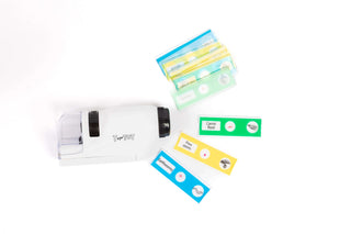 Close-up of a child-safe microscope with prepared specimen slides and exploration tools