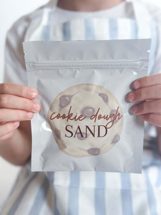 Child holding a pouch labeled