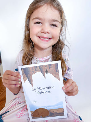 Child completing activities in hibernation notepad with included pen