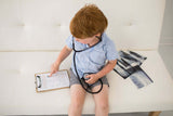 Boy listening to his heartbeat with the kit stethoscope