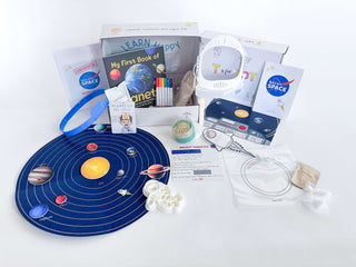 Complete Back to Space Kit contents displayed, including felt space mat, astronaut playdough cutter, and educational materials