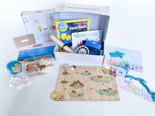 Learn and Play Kit contents including books, maps, and creative materials for educational fun.
