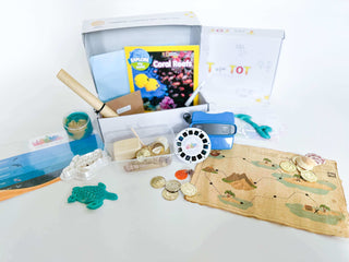 Learn and Play Kit with exploration items, a map, and educational materials for engaging creative experiences.