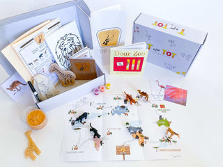 Ages 3-6. Zoo-themed play and learn kit for kids with giraffe playdough cutter, homemade playdough, zoo map, vet folder with expo marker, play animals, and