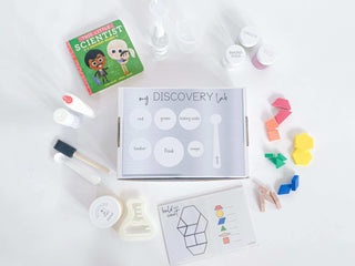 Play-based Discovery Kit for kids, including homemade playdough, custom flask playdough cutter, and science experiment materials. Includes a Little Scientist board book, art experiment supplies, and a detailed brochure with instructions.