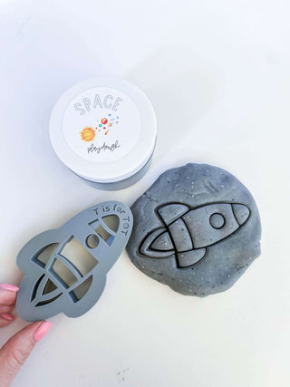 Homemade non-toxic playdough with rocket ship cutter. Early childhood education enhancing fine motor skills.