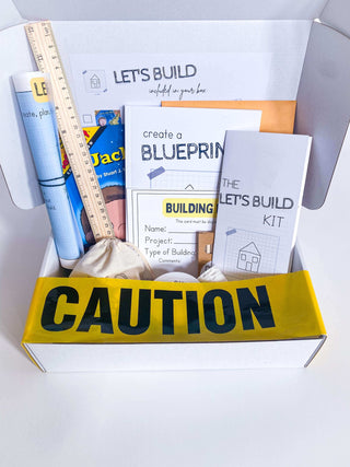 Play-based construction kit for children with homemade non-toxic playdough, brick playdough roller, building blocks, and role play items like blueprint and caution tape. Comes with a blueprint journal, ruler, and