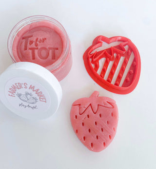 homemade non-toxic playdough cutter with strawberry themed cutter. Early Childhood education focusing on fine motor skill development.
