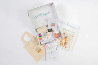 Library Kit contents including books, literacy tools, cards, and storytelling materials