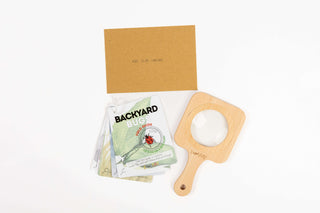 Adventure drawstring backpack with bug field guide and magnifying glass for outdoor exploration and observation