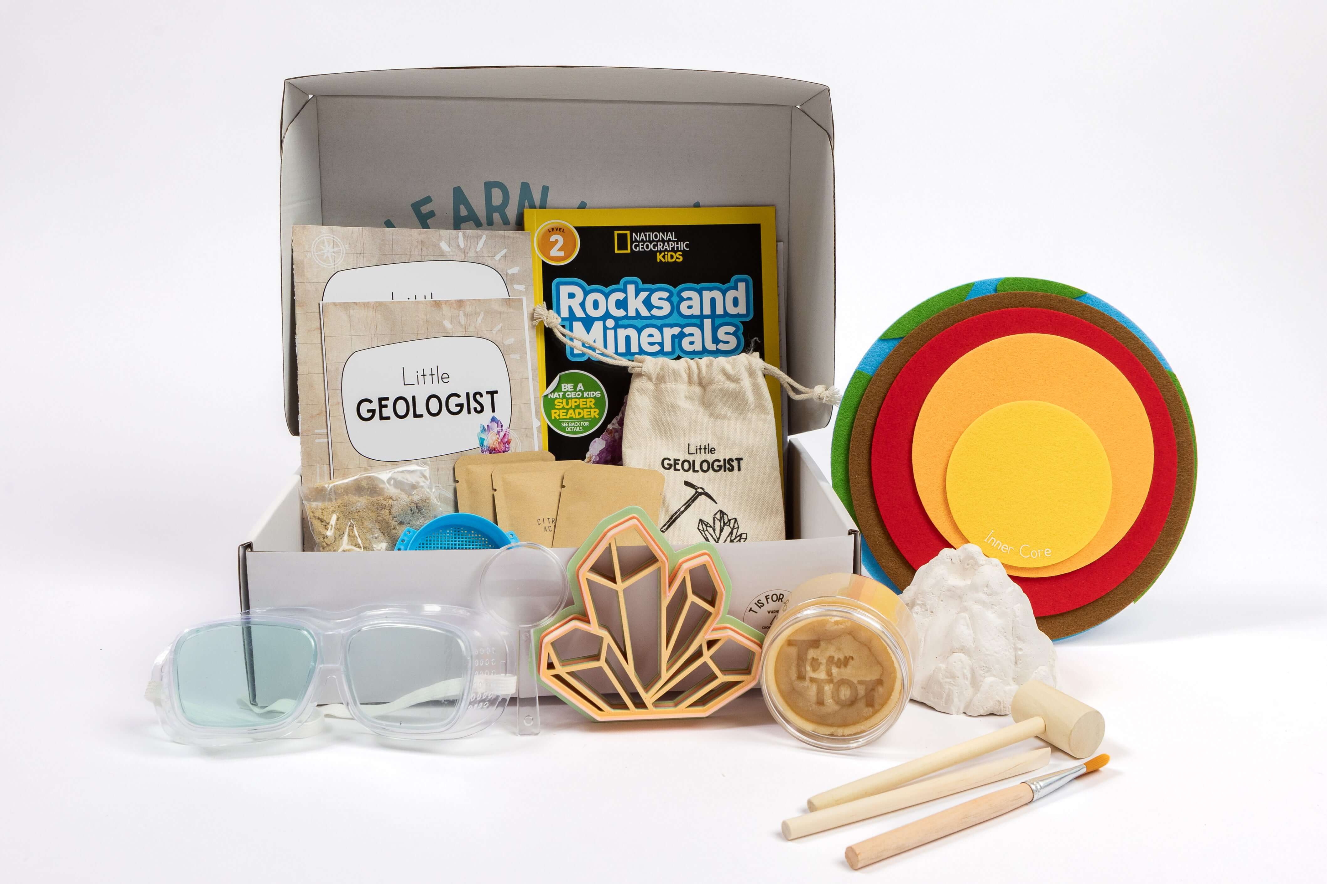 Little Geologist Kit contents including rock samples, tools, cards, and learning materials