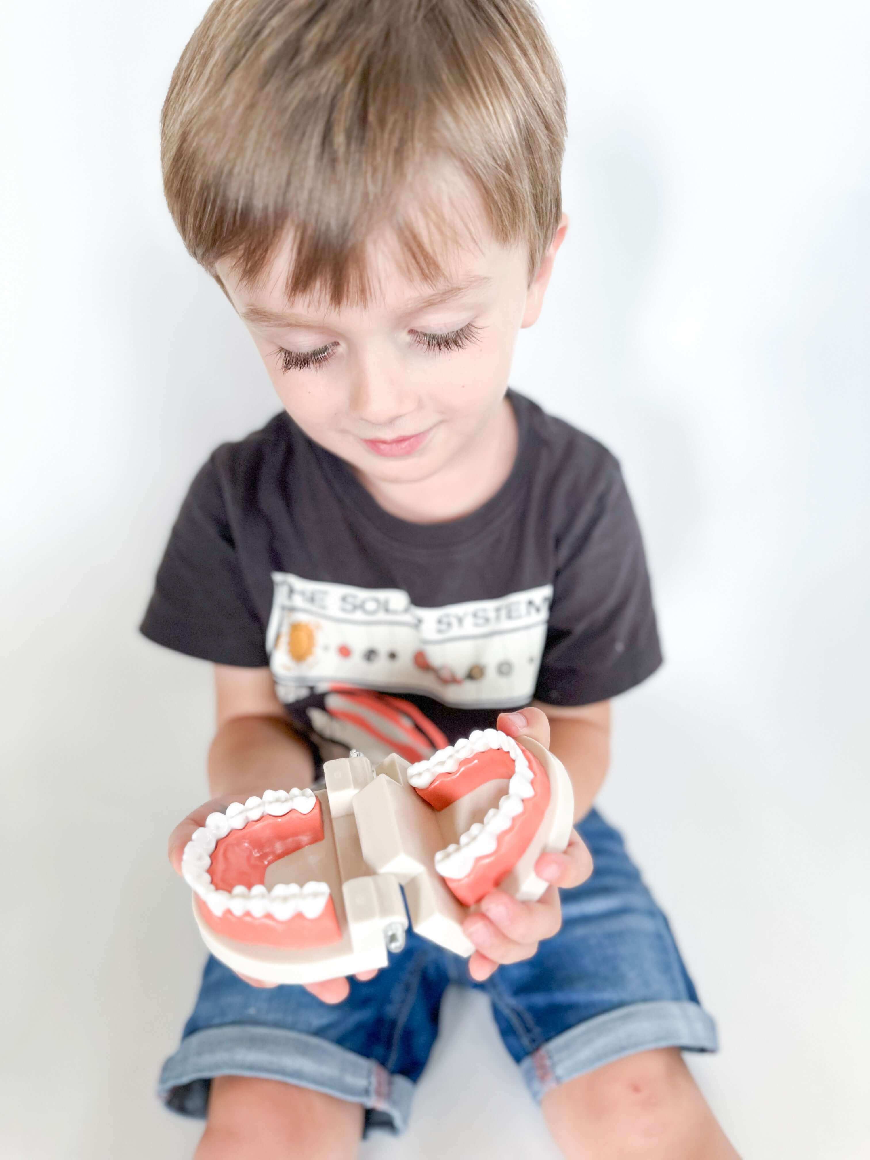 Fun Community Helpers play and learn kit for kids with fire engine playdough cutter, dental x-rays, library card rhyming game, homemade playdough, and pretend play items like mailbag and postcards. Ideal for ages 3-6.